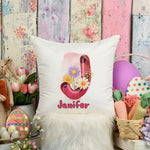 Decorative pillow with floral letter 'J' and name 'Janifer', surrounded by Easter decorations.