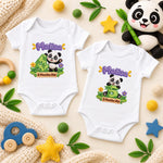 Two white personalised panda milestone bodysuits showing green numbers 4 and 5 with colourful nursery props.