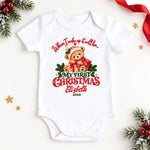White personalised “When I wake up it will be my first Christmas” bodysuit with a festive teddy bear and year.