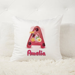 White pillow with a decorative letter 'A' and name 'Amelia' on a white background