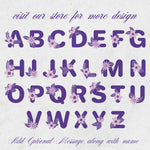 Purple floral alphabet letters on a textured white background with text inviting to visit a store for more designs.