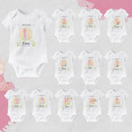 Set of baby bodysuits with numbers and names on a light gray background
