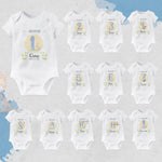 Set of baby bodysuits with milestone numbers and names on a light gray background
