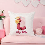 Decorative pillow with floral design and 'Lilly Beth' text on a pink couch.
