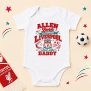 White personalised Allen Liverpool baby bodysuit with red and teal supporter lettering, club crest and footballs.