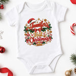 White personalised first Christmas 2026 baby bodysuit with red script, holly and festive decorations on white.