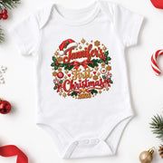 White personalised first Christmas 2026 baby bodysuit with red script, holly and festive decorations on white.
