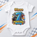 White personalised 7 months old today racing baby bodysuit with a blue number, tyre and chequered flag.
