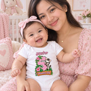 Woman holding a smiling baby wearing a personalised 5 months old safari bodysuit with flowers and green leaves.