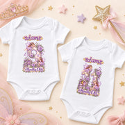 Two white personalised fairy princess milestone bodysuits with purple floral numbers 9 and 10 on peach.